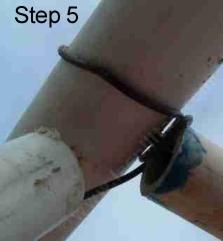 pull the wire through a four foot piece of pvc,then through the holes you drilled in the pvc,  wrap it around this pvc so the green house can't shift and then through the next 4 ft piece of pvc.